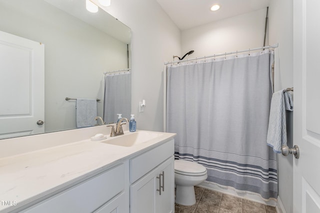 bathroom featuring toilet, vanity, and a shower with curtain