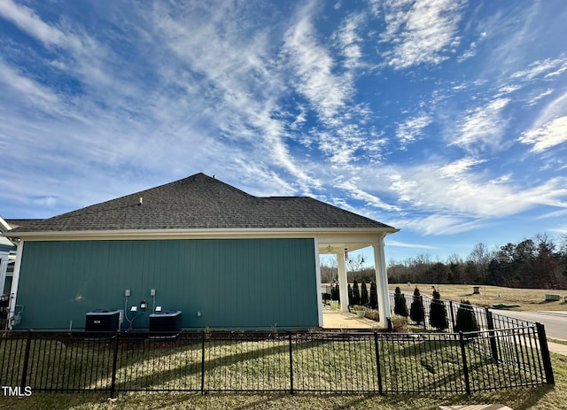 view of side of home with central air condition unit