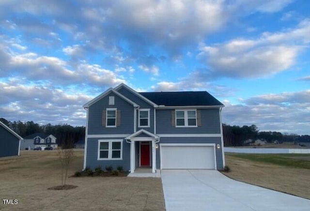 front facade featuring a front yard and a garage