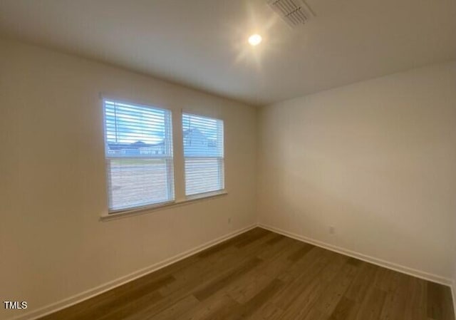 empty room with dark wood-type flooring