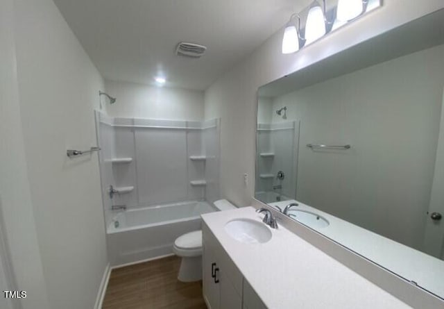 full bathroom with hardwood / wood-style flooring, vanity, bathing tub / shower combination, and toilet