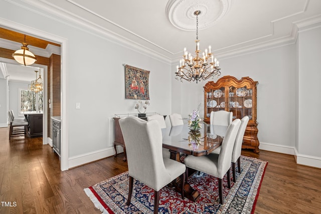 dining space featuring an inviting chandelier, baseboards, dark wood-type flooring, and ornamental molding