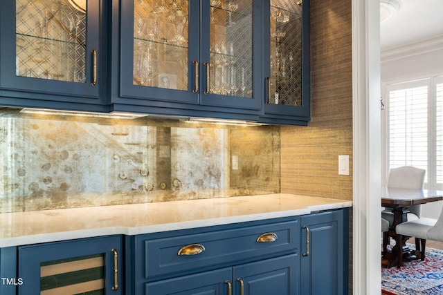 bar featuring crown molding, wine cooler, and tasteful backsplash