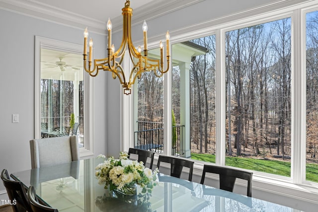 dining space featuring crown molding and a notable chandelier