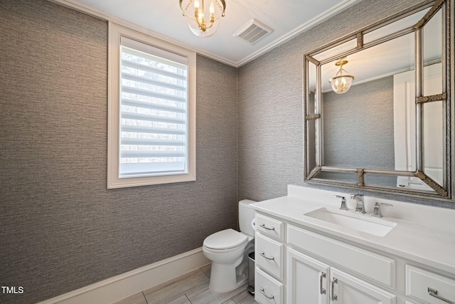 bathroom with visible vents, baseboards, toilet, an inviting chandelier, and vanity