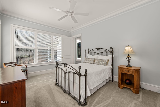 bedroom featuring ceiling fan, crown molding, baseboards, and light carpet