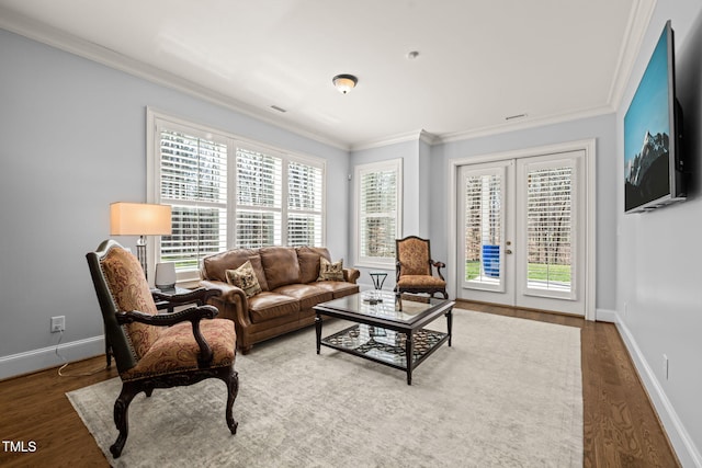 living room with crown molding, wood finished floors, baseboards, and french doors