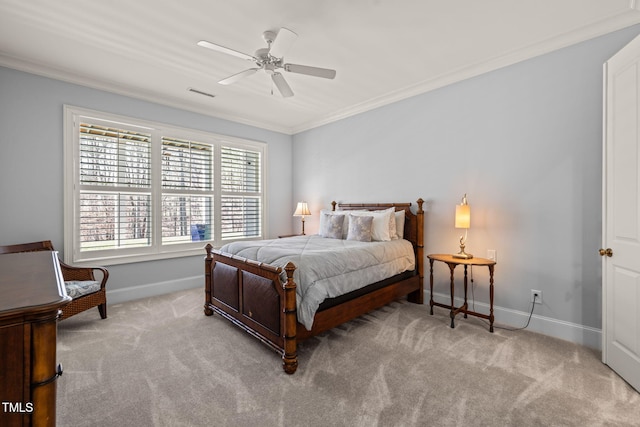 carpeted bedroom featuring visible vents, baseboards, ornamental molding, and a ceiling fan