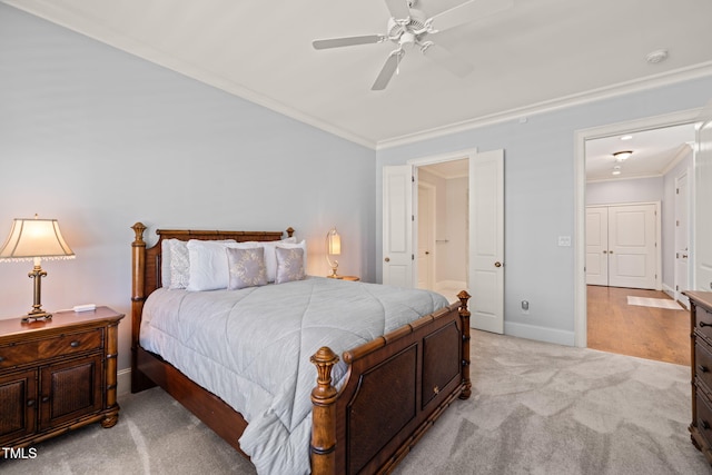 bedroom with light colored carpet, ceiling fan, baseboards, and ornamental molding