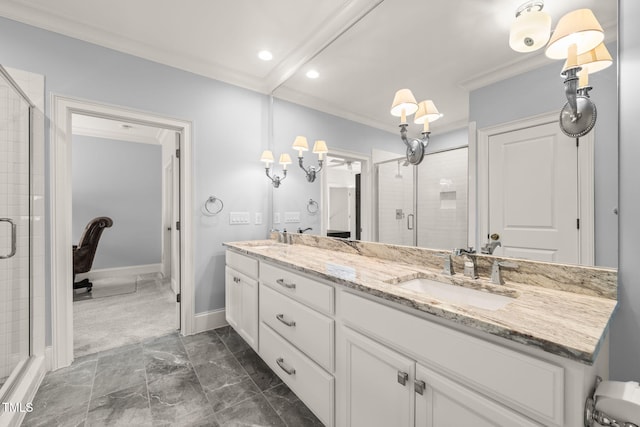 bathroom with a stall shower, a sink, crown molding, double vanity, and baseboards