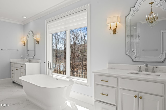 full bathroom with two vanities, marble finish floor, a sink, crown molding, and a freestanding bath