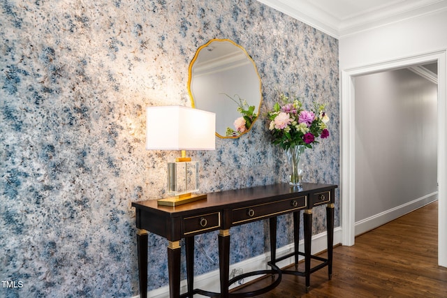 interior space featuring wallpapered walls, crown molding, wood finished floors, and baseboards