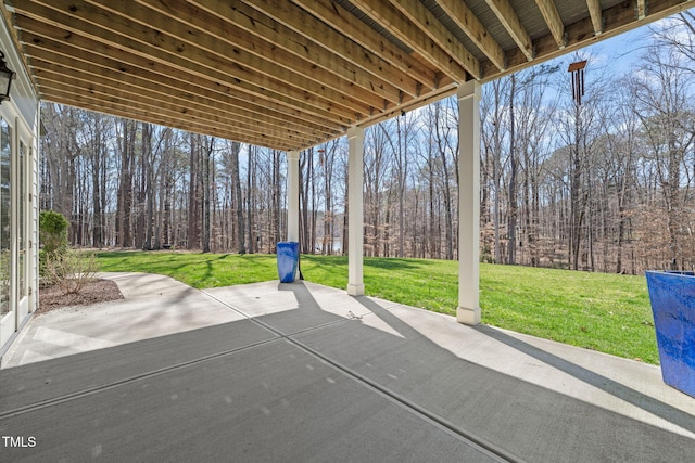 view of patio / terrace with a forest view