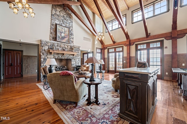 living room featuring hardwood / wood-style floors, a notable chandelier, and wainscoting