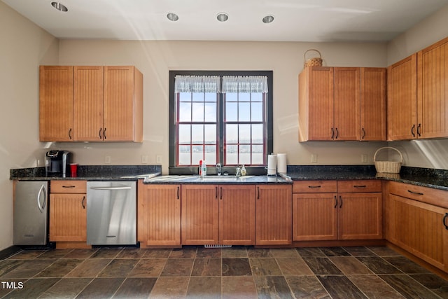 kitchen with recessed lighting, dark stone countertops, refrigerator, and stone finish flooring