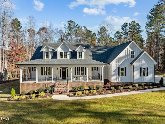 modern farmhouse with board and batten siding, roof with shingles, a porch, and a front lawn