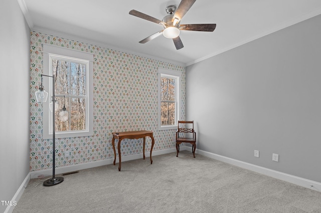 living area with carpet flooring, plenty of natural light, crown molding, and baseboards