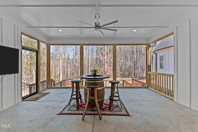 sunroom featuring a ceiling fan