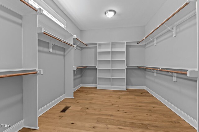 spacious closet with visible vents and wood finished floors