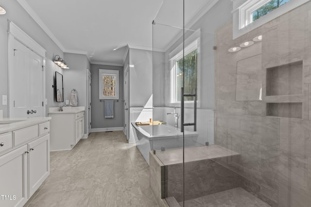 full bath featuring a freestanding bath, two vanities, a stall shower, and crown molding