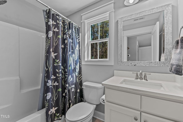 bathroom featuring visible vents, shower / tub combo, toilet, and vanity