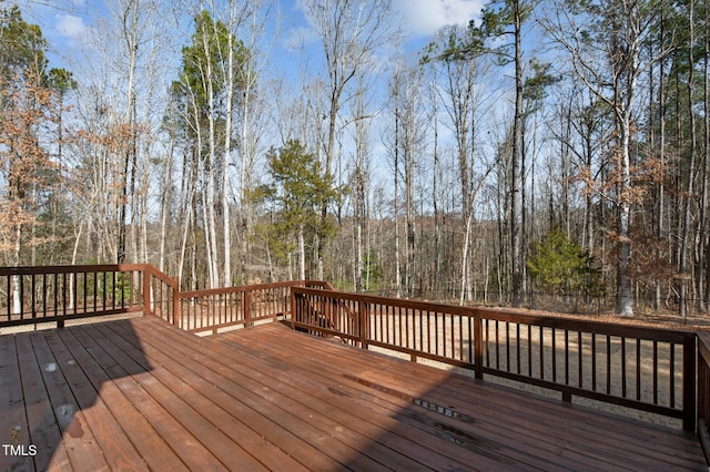 wooden terrace with a view of trees