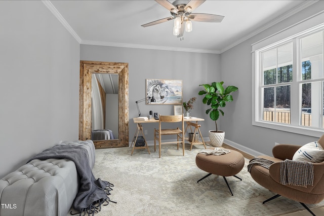 carpeted home office with baseboards, a ceiling fan, and crown molding