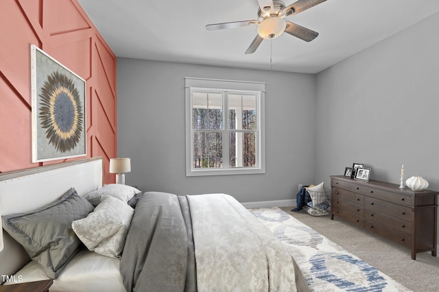 carpeted bedroom with a ceiling fan and baseboards