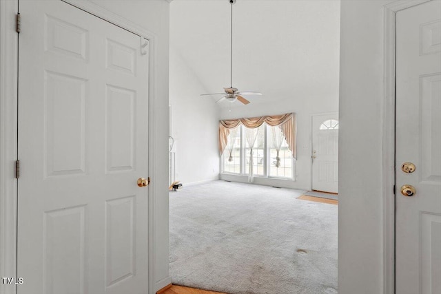 interior space with high vaulted ceiling, baseboards, and carpet floors