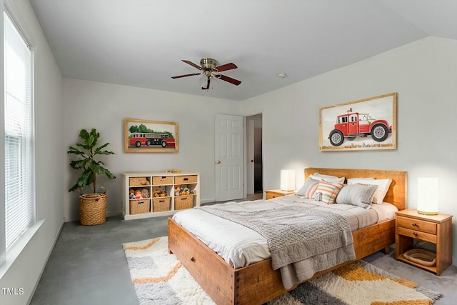 carpeted bedroom with a ceiling fan and vaulted ceiling