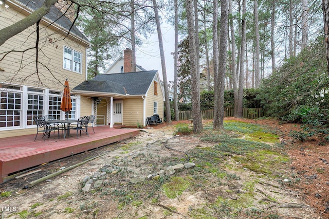 view of yard featuring outdoor dining space, fence, and a deck