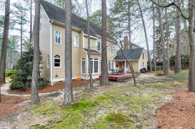 back of property with crawl space and a wooden deck