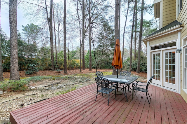 wooden deck with french doors and outdoor dining area