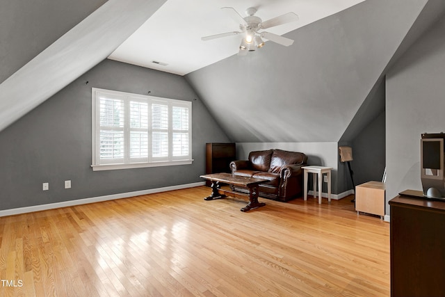 sitting room featuring visible vents, baseboards, a ceiling fan, wood-type flooring, and vaulted ceiling