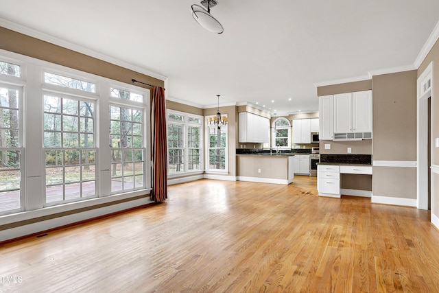 unfurnished living room with a chandelier, a sink, baseboards, light wood-style floors, and crown molding