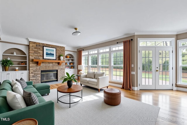 living room with crown molding, light wood finished floors, and a healthy amount of sunlight