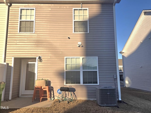 back of house with central air condition unit and a patio