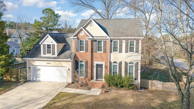 view of front of property with brick siding, concrete driveway, a shingled roof, an attached garage, and fence