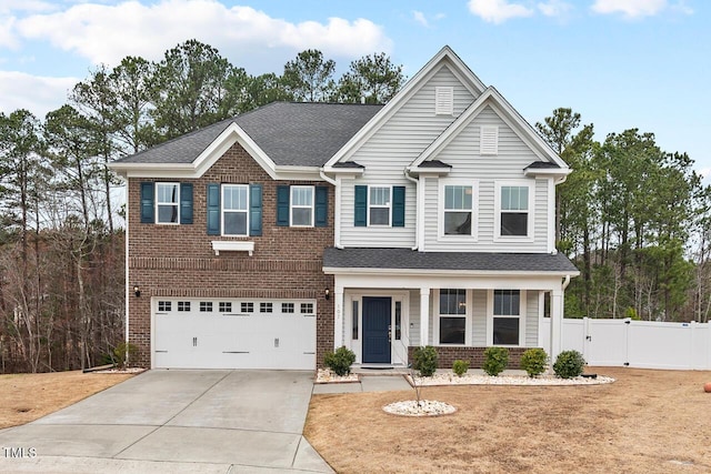 view of front of house featuring driveway, a gate, fence, a garage, and brick siding