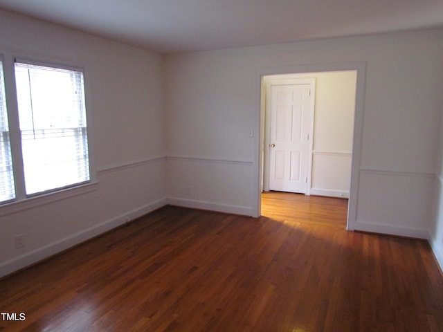 empty room with dark wood-type flooring