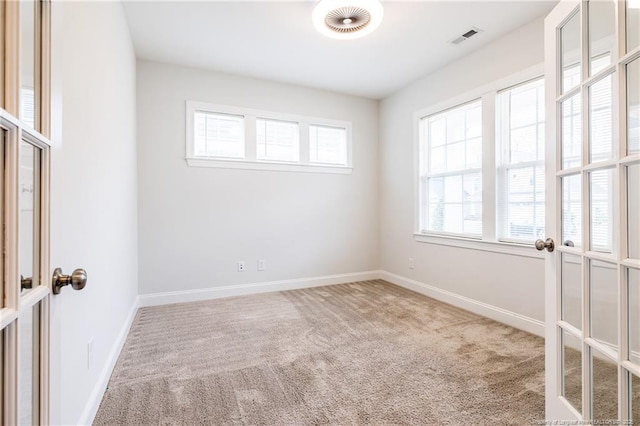 unfurnished room with french doors and carpet flooring