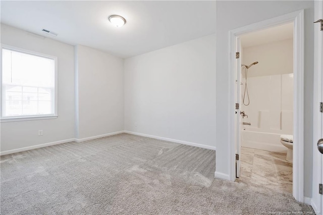 spare room featuring light colored carpet