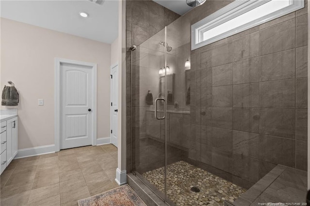 bathroom with vanity and a shower with door