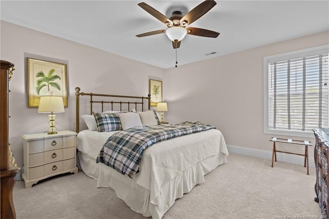 bedroom featuring light carpet and ceiling fan