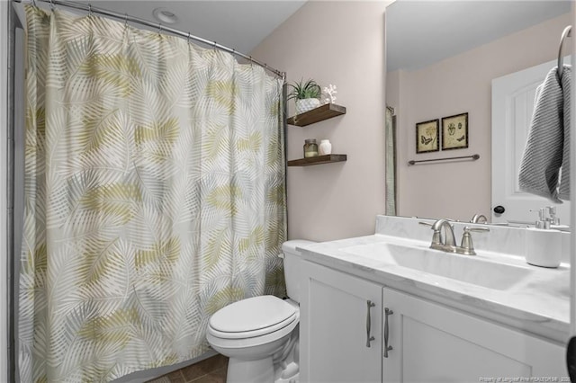 bathroom featuring vanity and toilet