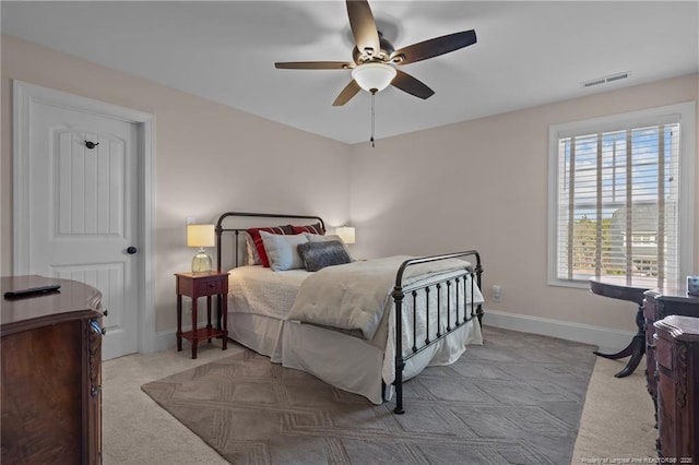 bedroom featuring ceiling fan and light colored carpet