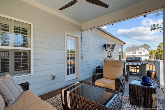 wooden deck featuring an outdoor living space, ceiling fan, and grilling area