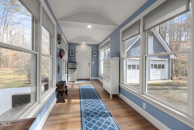 interior space featuring plenty of natural light, vaulted ceiling, and hardwood / wood-style floors