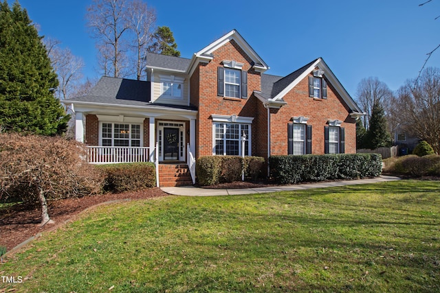 traditional-style house featuring brick siding and a front lawn