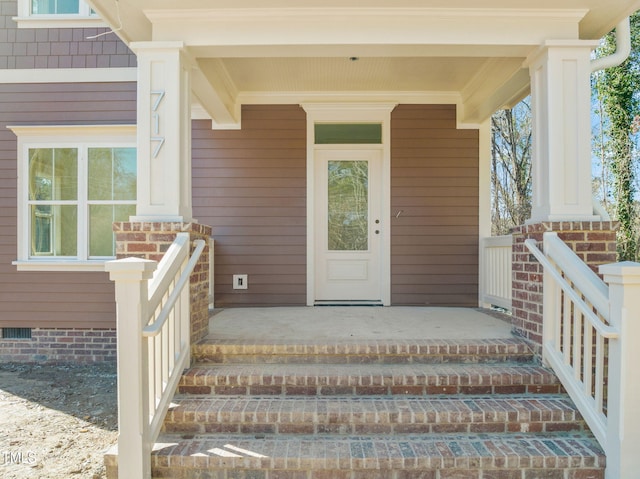 view of exterior entry with a porch